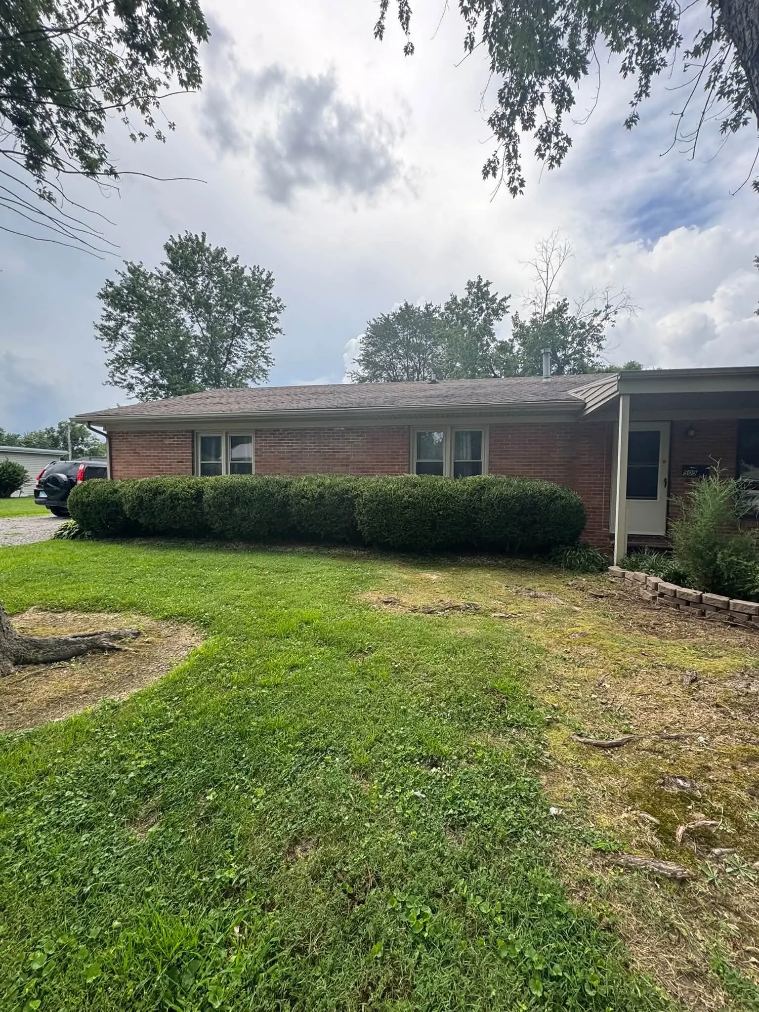 Trimmed shrubs and clean front lawn